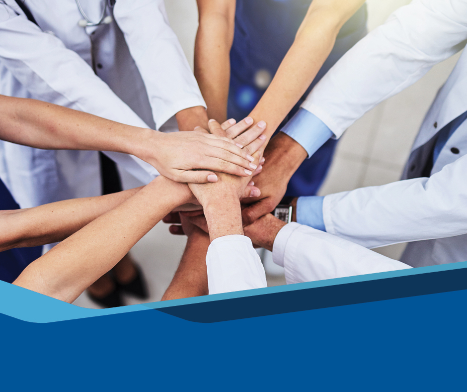 Physicians and nurses putting their hands in a circle